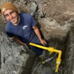 man repairing drain pipe