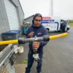 man holding drain pipe